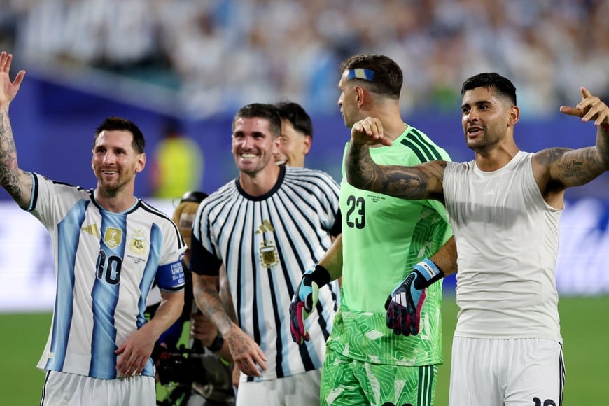 Soccer Football - FIFA World Cup 2026 - Round of 32 - Argentina v Cape Verde - Miami Stadium, Miami Gardens, Florida, U.S. - July 3, 2026
Argentina's Lionel Messi, Rodrigo De Paul, Emiliano Martinez and Cristian Romero celebrate after the match as Argentina qualify for the Round of 16 stage of the World Cup REUTERS/Paul Childs