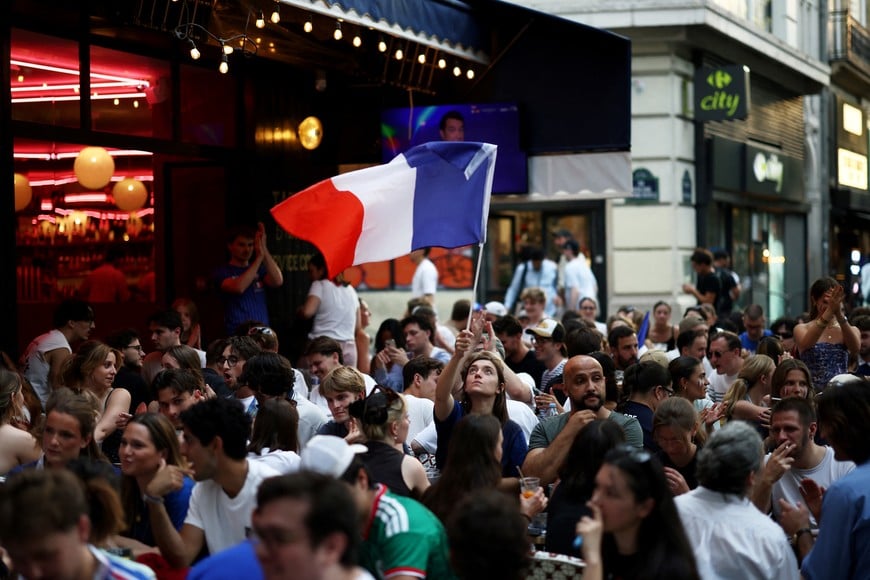 Soccer Football - FIFA World Cup 2026 - Semi Final - France v Spain - Fans gather in Paris - Paris, France - July 14, 2026
France fan waves a national flag before the match REUTERS/Tom Nicholson