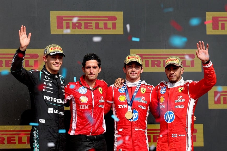Formula One F1 - British Grand Prix - Silverstone Circuit, Silverstone, Britain - July 5, 2026
Ferrari's Charles Leclerc celebrates on the podium after winning the British Grand Prix with Mercedes' George Russell who finished second, Ferrari's Lewis Hamilton who finished third and Ferrari race engineer Bryan Bozzi REUTERS/Andrew Boyers TPX IMAGES OF THE DAY
