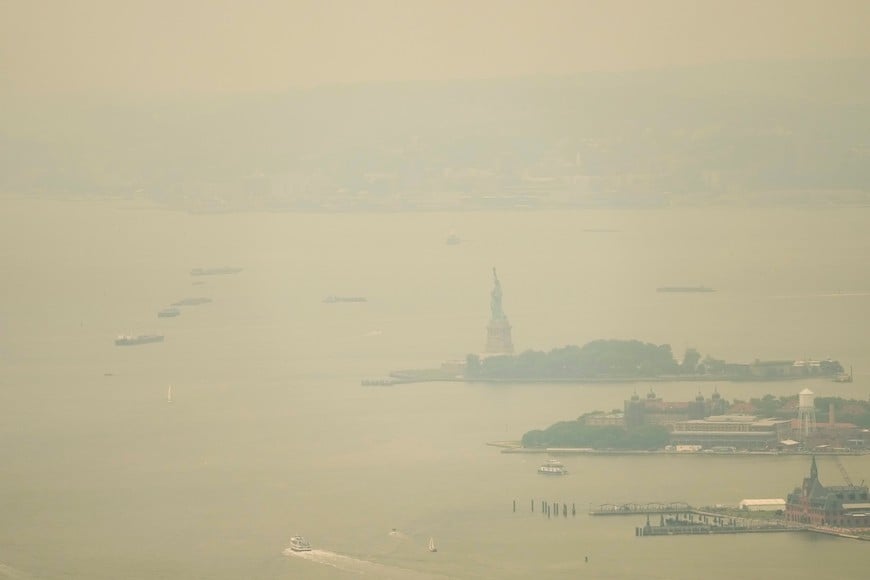 The Statue of Liberty is seen through a cover of wildfire smoke in New York City, U.S., July 16, 2026. REUTERS/Eduardo Munoz