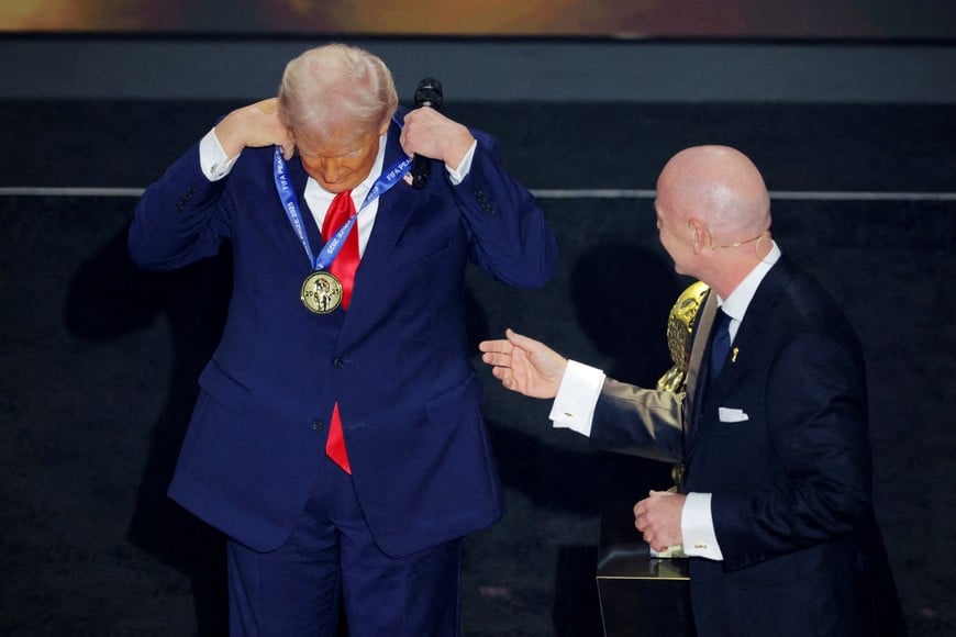 FILE PHOTO: Soccer Football - FIFA World Cup 2026 - FIFA World Cup 2026 Draw - John F. Kennedy Center for the Performing Arts, Washington, D.C., U.S. - December 5, 2025
U.S. President Donald Trump on stage with FIFA President Gianni Infantino as he is awarded the FIFA Peace Prize REUTERS/Carlos Barria/File Photo