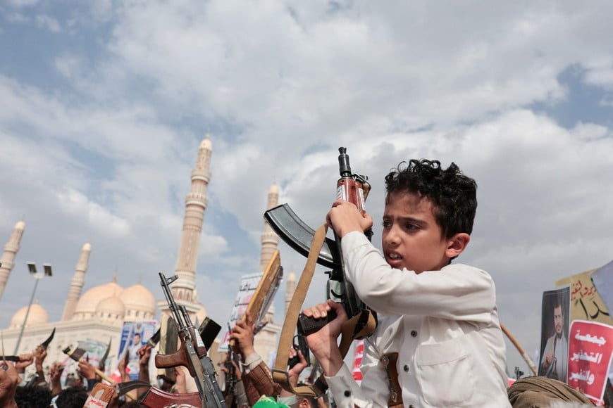 A boy holds a rifle as Houthi supporters rally against the Saudi-led coalition's restrictions on Houthi-controlled areas, which the group describes as a blockade, in Sanaa, Yemen, July 17, 2026. REUTERS/Khaled Abdullah