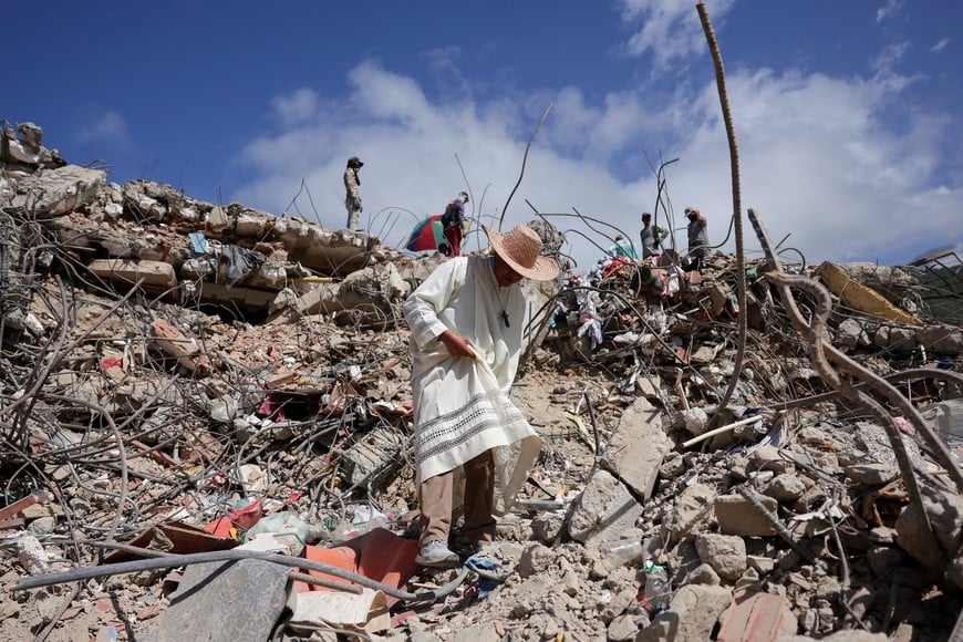 A priest walks through the debris of a collapsed building in the aftermath of the June 24 earthquakes in La Guaira, Venezuela, July 17, 2026. REUTERS/Gaby Oraa TPX IMAGES OF THE DAY