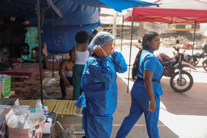 Medical personnel operate in the area as people search for the bodies of their loved ones beneath the rubble in the aftermath of the June 24 earthquakes in La Guaira, Venezuela, July 18, 2026. REUTERS/Leonardo Fernandez Viloria