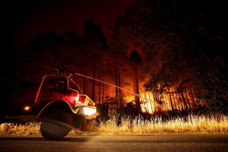 A firefighter works in Le Porge as a wildfire burns in a forest area in the Gironde department amid worsening drought conditions following a heatwave and water shortages across much of France, July 22, 2026. REUTERS/Stephane Mahe