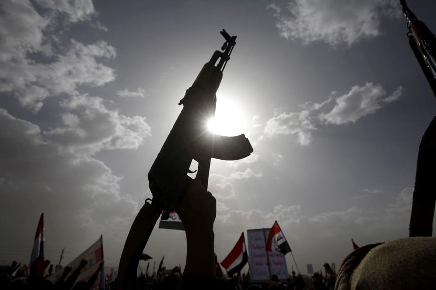 FILE PHOTO: A Houthi follower rises a weapon as he attends a rally marking one year of Saudi-led air strikes, in Yemen's capital Sanaa, March 26, 2016. REUTERS/Mohamed al-Sayaghi/File Photo