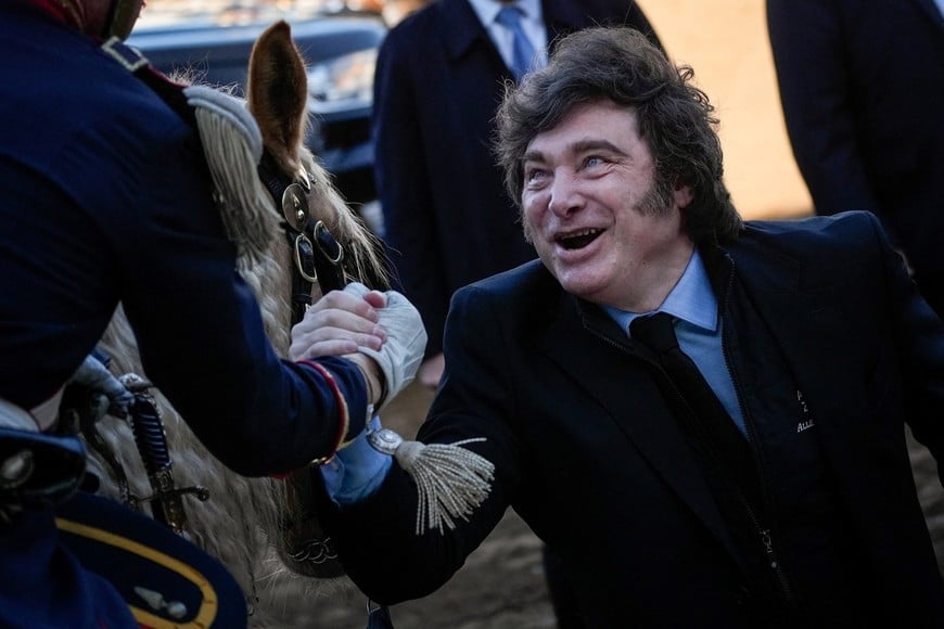 Argentina's President Javier Milei greets a mounted presidential guard as he attends the opening ceremony of the Rural Society's 138th annual exhibition, in Buenos Aires, Argentina, July 26, 2026. REUTERS/Mariana Nedelcu