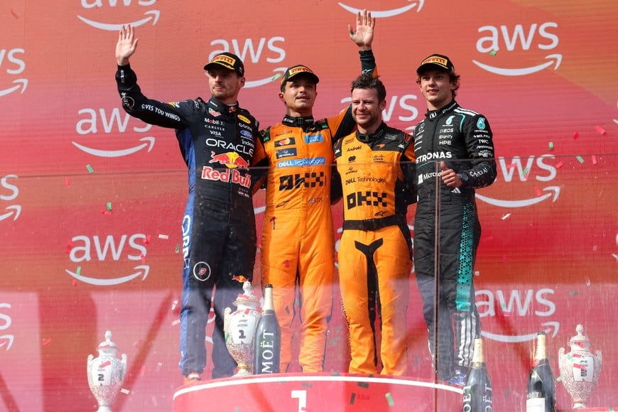 Formula One F1 - Hungarian Grand Prix - Hungaroring, Budapest, Hungary - July 26, 2026
McLaren's Lando Norris celebrates on the podium after winning the Hungarian Grand Prix with second placed Red Bull's Max Verstappen and third placed Mercedes' Andrea Kimi Antonelli REUTERS/Bernadett Szabo     TPX IMAGES OF THE DAY