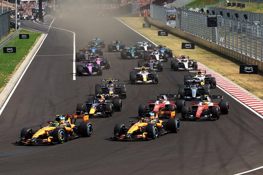 Formula One F1 - Hungarian Grand Prix - Hungaroring, Budapest, Hungary - July 26, 2026
McLaren's Lando Norris leads into the first corner at the start of the race ahead of McLaren's Oscar Piastri REUTERS/Bernadett Szabo TPX IMAGES OF THE DAY
