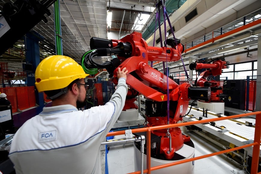 FILE PHOTO: A Mirafiori FCA worker is seen during the installation of the first robot on the production line for the new electric Fiat 500 BEV at the Mirafiori industrial complex on the 80th birthday of the plant in Turin, Italy July 11, 2019. REUTERS/Massimo Pinca/File Photo