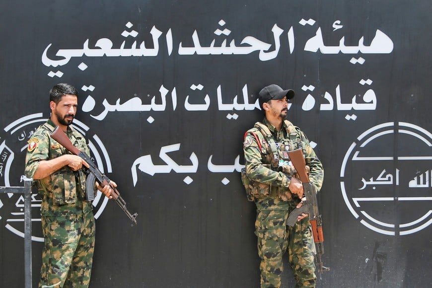 Members of Iraq's Popular Mobilization Forces (PMF) stand guard outside the Basra Operations Command headquarters, following airstrikes that the PMF said were carried out by U.S. and Saudi forces in Basra, Iraq July 29, 2026. REUTERS/Essam Al-Sudani