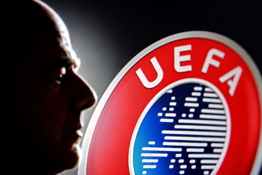 A silhouette depicting FIFA President Gianni Infantino is seen next to a UEFA logo in this illustration taken July 30, 2026. REUTERS/Dado Ruvic/Illustration