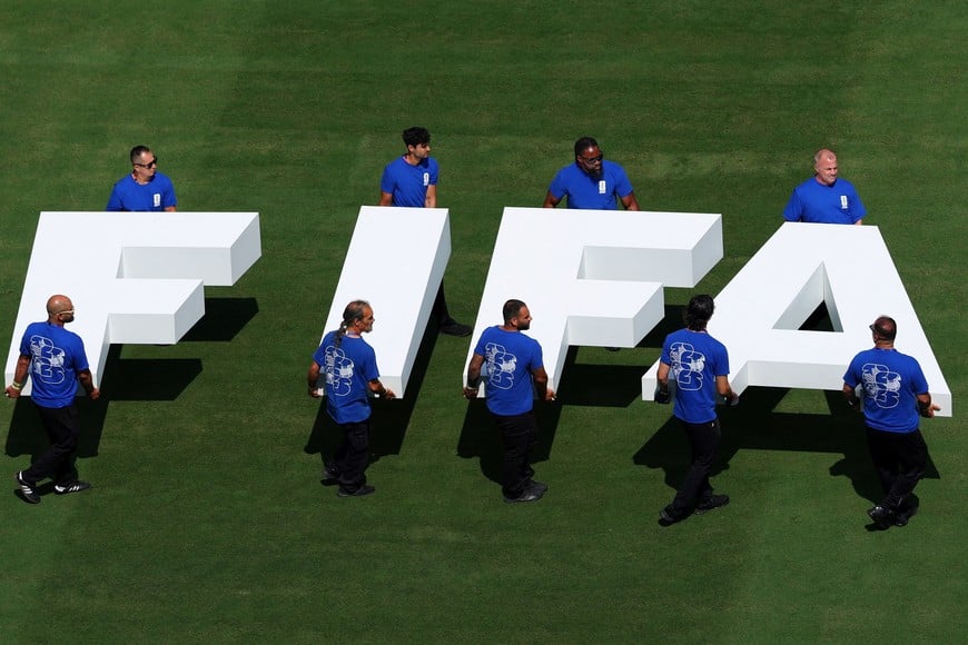 FILE PHOTO: Soccer Football - FIFA World Cup 2026 - Final - Spain v Argentina - New York/New Jersey Stadium, East Rutherford, New Jersey, U.S. - July 19, 2026
Pitch staff carry the FIFA logo on the pitch before the match REUTERS/Mike Segar/File Photo