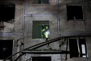 A firefighter works at the site of an apartment building hit by a Russian missile strike, amid Russia's attack on Ukraine, in Kyiv, Ukraine, August 1, 2026. REUTERS/Gleb Garanich