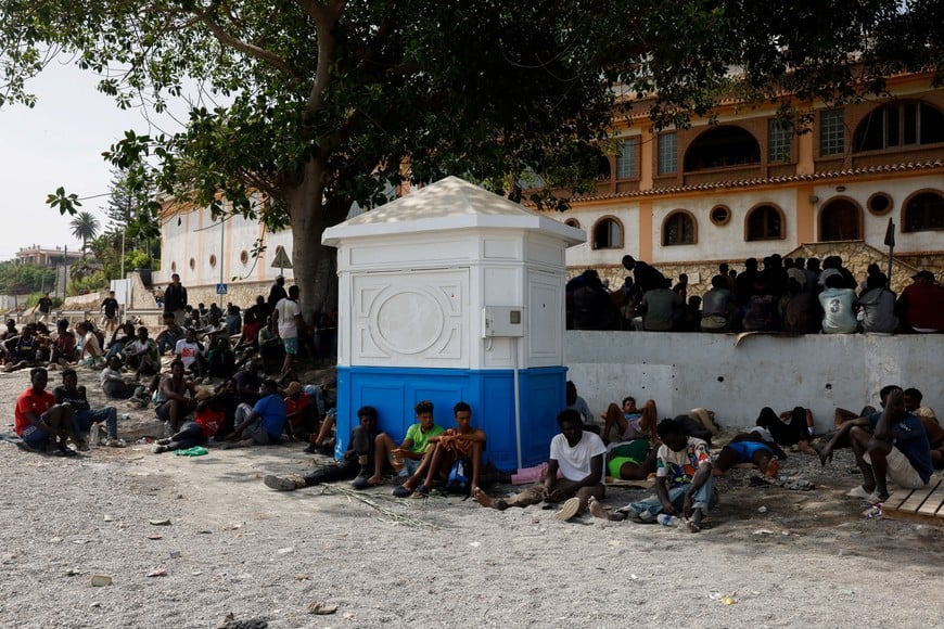 Migrants wait to enter a short-stay migrants centre CETI, following mass crossings of migrants on foot and by sea from Morocco into Spanish territory, in Ceuta, Spain, August 1, 2026. REUTERS/Jon Nazca