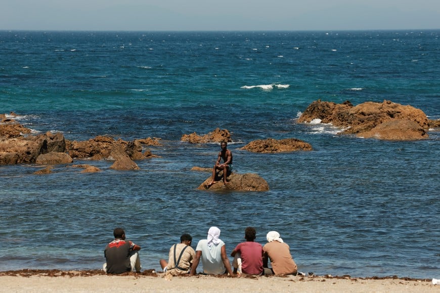 Migrants wait on the beach in Ceuta, Spain, following deadly mass crossings of migrants on foot and by sea from Morocco into Spanish territory, August 2, 2026. REUTERS/Violeta Santos Moura