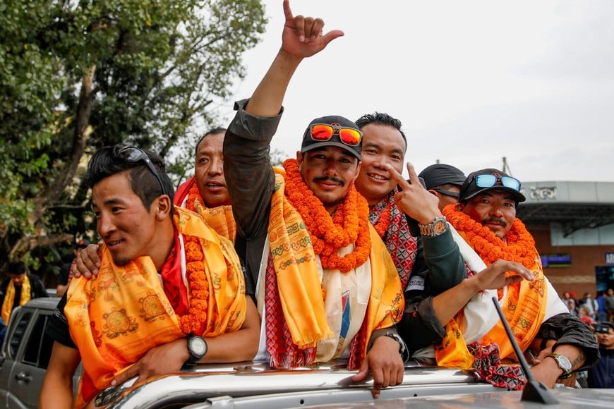 Nirmal Purja, who became the fastest person to summit the world's 14 highest mountains, gestures upon his arrival at Tribhuvan International Airport in Kathmandu, Nepal, October 30, 2019. Picture taken October 30, 2019. REUTERS/Navesh Chitrakar