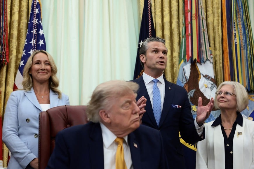 U.S. Secretary of Defense Pete Hegseth speaks as U.S. President Donald Trump signs an executive order establishing the President's Military Spouse Commission to be chaired by Jennifer Rauchet, wife of Hegseth, in the Oval Office at the White House in Washington, D.C., U.S., August 3, 2026. REUTERS/Evelyn Hockstein