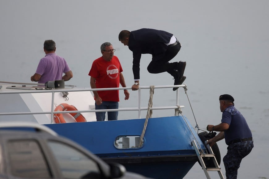 Romanian Minister of National Defence Radu Miruta heads to the controlled explosion site on Bala channel, performed by Navy forces in an attempt to divert the Danube water flow toward the Cernavoda nuclear power plant, in Izvoarele, Romania, August 3, 2026. Inquam Photos/George Calin via REUTERS ATTENTION EDITORS - THIS IMAGE WAS PROVIDED BY A THIRD PARTY. ROMANIA OUT. NO COMMERCIAL OR EDITORIAL SALES IN ROMANIA