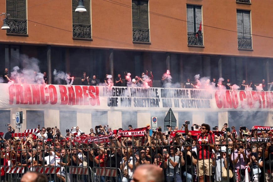 Mourners hold flares during the funeral of former AC Milan and Italy soccer player Franco Baresi outside the Basilica of Sant'Ambrogio, in Milan, Italy, August 4, 2026. REUTERS/Yara Nardi