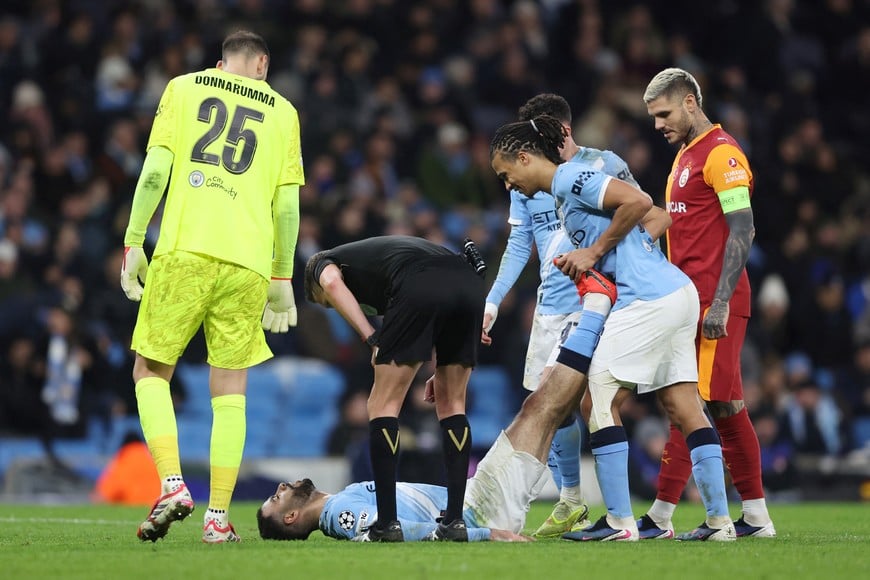 Soccer Football - UEFA Champions League - Manchester City v Galatasaray - Etihad Stadium, Manchester, Britain - January 28, 2026
Manchester City's Nathan Ake assists Rayan Ait-Nouri with cramp as Gianluigi Donnarumma, referee Alejandro Hernandez and Galatasaray's Mauro Icardi look on REUTERS/Scott Heppell