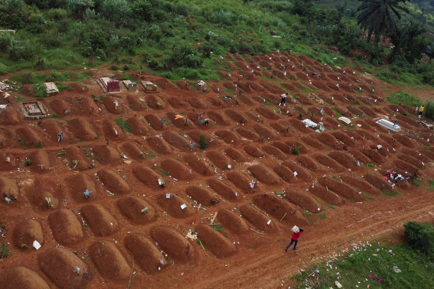 A drone view of workers at the Ceca-20 cemetery, as aid agencies intensify efforts to contain an Ebola outbreak caused by the Bundibugyo virus, in Mungwalu, Djugu Territory of Ituri province, Democratic Republic of Congo, July 14, 2026. REUTERS/Gradel Muyisa Mumbere     TPX IMAGES OF THE DAY