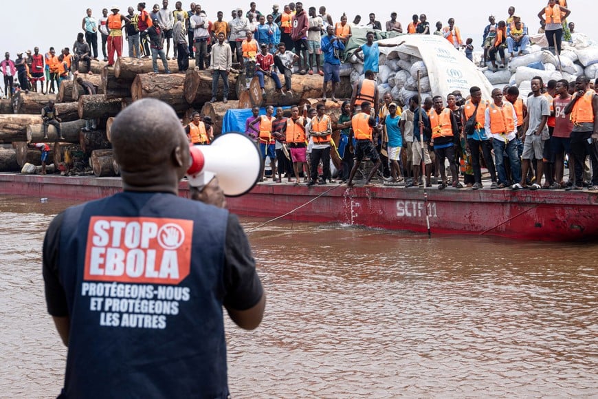 A volunteer uses a megaphone to make announcements while intercepting a passenger boat, after, according to officials, a passenger who had disembarked earlier died after developing symptoms consistent with Ebola, in a place given as Kinshasa, Democratic Republic of the Congo, in this handout image released on August 5, 2026. International Organization For Migration/Handout via REUTERS THIS IMAGE HAS BEEN SUPPLIED BY A THIRD PARTY. NO RESALES. NO ARCHIVES. MANDATORY CREDIT.

VERIFICATION: 
- Exact location and date not verified 
- Reuters reported that Congolese health authorities have intercepted a boat in Maluku carrying 200 people to the capital Kinshasa
- No older versions found posted online before August 6