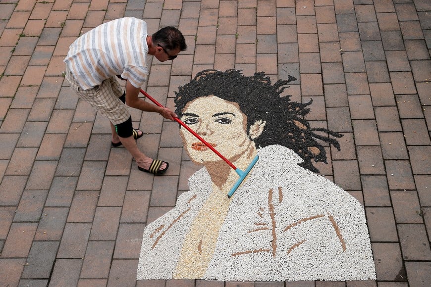 Kosovo artist Alkent Pozhegu works on a mosaic made of grains showing a portrait of Michael Jackson on the 15th anniversary of his death in Gjakova, Kosovo June 25, 2024. REUTERS/Valdrin Xhemaj