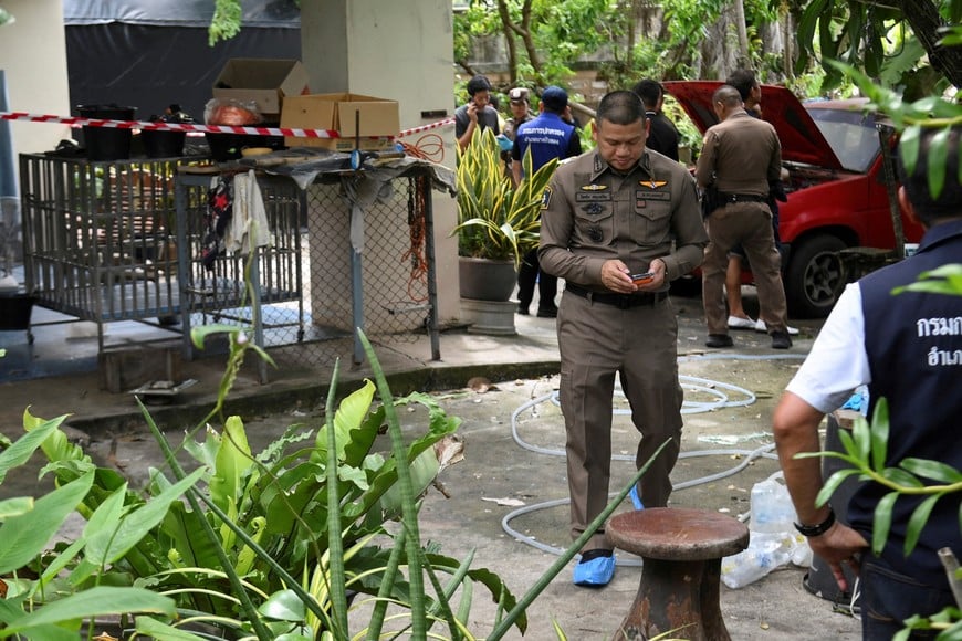 Police officers work at a residence, where according to them, the shooter killed his grandparents before opening fire at the Debsirin Nonthaburi School, in Bang Bua Thong District of Nonthaburi province, on the outskirts of Bangkok, Thailand, August 7, 2026. REUTERS/Tananchai Keawsowattana REFILE – CORRECTING BYLINE