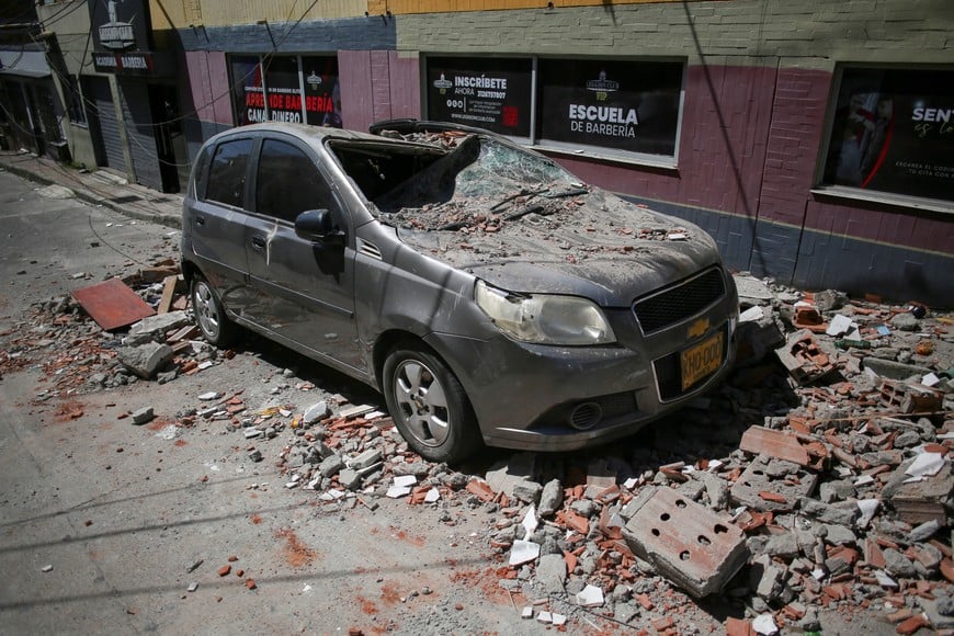 A damaged car sits covered with debris after an earthquake, in Dosquebradas, Colombia, August 10, 2026. REUTERS/Juan David Duque