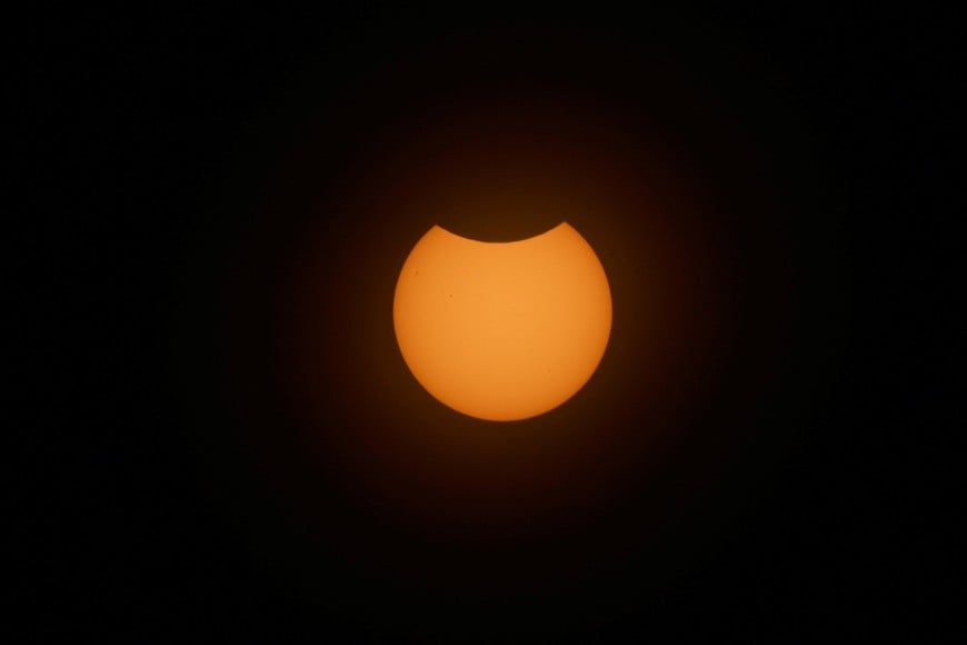 The moon partially covers the sun during a solar eclipse, in New York, U.S., August 12, 2026. REUTERS/Jordan Tovin