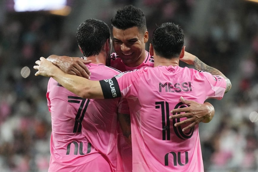Aug 5, 2026; Miami, FL, USA; Inter Miami’s Carlos Henrique Casiniro, center, hugs forward Lionel Messi (10) and Rodrigo de Paul (7) after Messi’s second goal against Atlético San Luis during the first half of a Leagues Cup Phase One match at Nu Stadium. Mandatory Credit: Jim Rassol-Imagn Images
