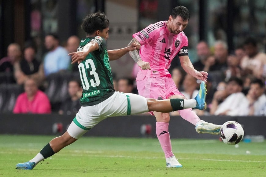 Aug 12, 2026; Miami, FL, USA; Inter Miami CF offense Leo Messi (10) passes the ball as León midfielder Jesus Lara (203) defends during the second half of the Leagues Cup Phase One match at Nu Stadium. Mandatory Credit: Jim Rassol-Imagn Images
