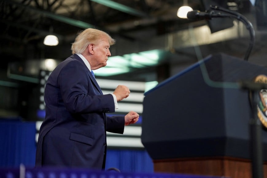 U.S. President Donald Trump dances on stage during an event at David S. Mack Center for Training and Intelligence in Garden City, New York, U.S., August 14, 2026. REUTERS/Ken Cedeno