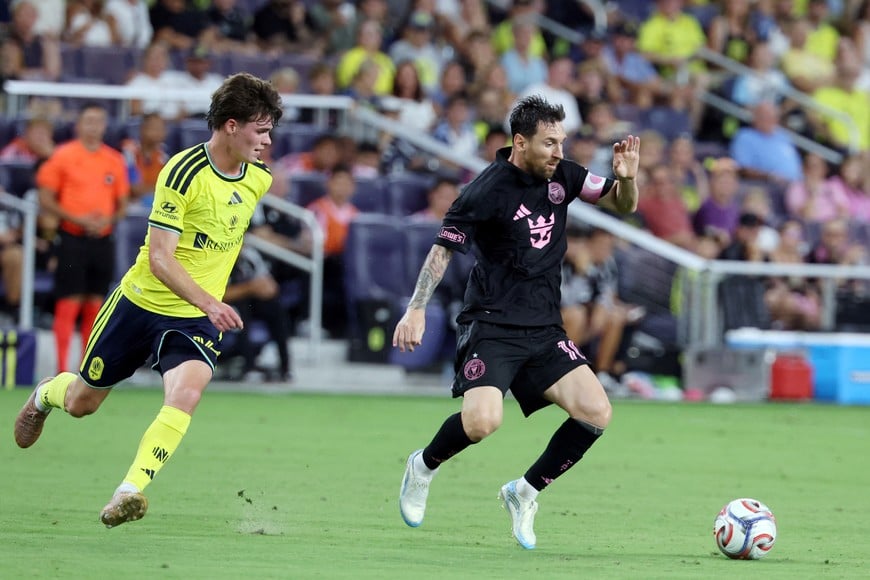 Aug 15, 2026; Nashville, Tennessee, USA; Inter Miami CF forward Lionel Messi (10) moves the ball past Nashville SC defender Matthew Corcoran (16) during the first half at Geodis Park. Mandatory Credit: Alan Poizner-Imagn Images