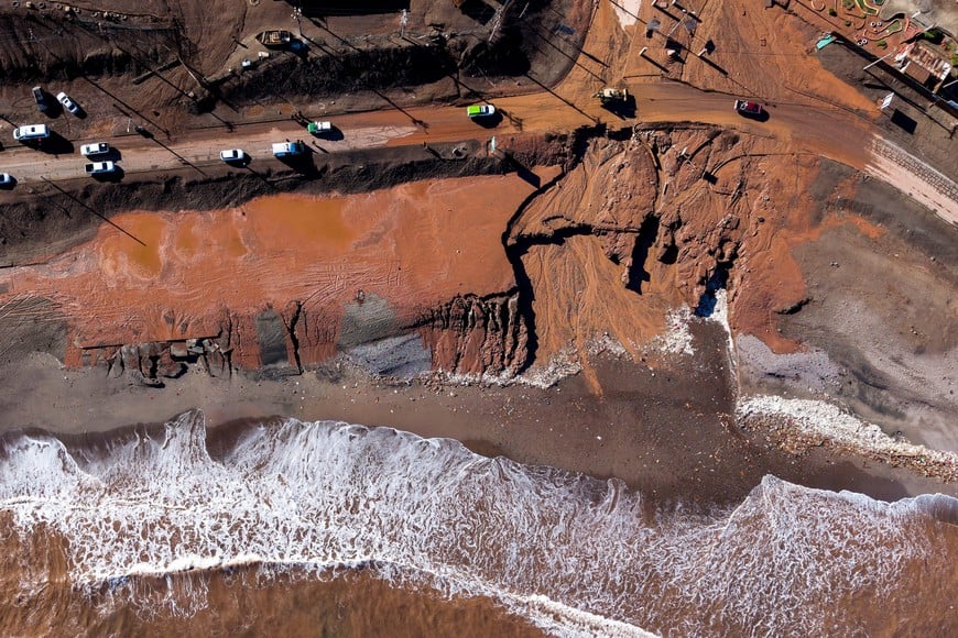 A drone view shows people dislodging boats and vehicles after heavy rains and flooding caused a mudslide, in Coloso, Chile August 19, 2026. REUTERS/Cristian Rudolffi