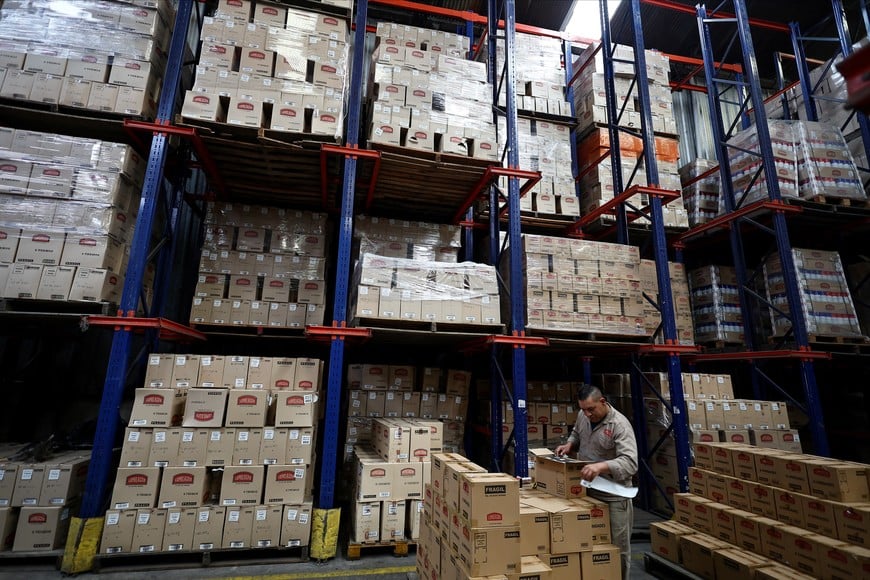An employee checks boxes at Lumilagro’s factory, which now operates only one of its four assembly lines due to cheaper imported components and reduced demand, as Argentines face reduced consumer purchasing power under President Javier Milei’s austerity measures, in Tortuguitas, on the outskirts of Buenos Aires, Argentina, October 3, 2025. REUTERS/Agustin Marcarian