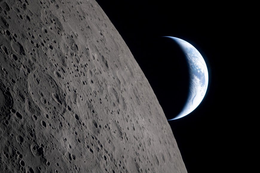 FILE PHOTO: A view of Earth, partially hidden by the Moon, photographed through the Orion spacecraft window at 6:40 p.m. EDT (22:40 GMT) April 6, 2026, just four minutes before the Orion spacecraft and its crew went behind the Moon and lost contact with Earth for 40 minutes before emerging on the other side during the Artemis II crew’s flyby of the Moon. According to the image file data the picture was taken with a Nikon D5 camera and 80-400mm lens. Picture released April 7, 2026.- NASA/Handout via REUTERS THIS IMAGE HAS BEEN SUPPLIED BY A THIRD PARTY/File Photo