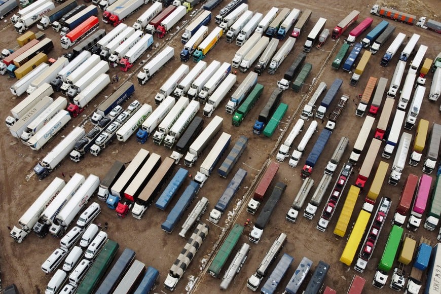 A drone view shows parked trucks as truckers wait for the Cristo Redentor border crossing between Argentina and Chile to reopen after heavy snowfall forced its closure, in Uspallata, Mendoza province, Argentina, July 22, 2026. REUTERS/Maximiliano Rios