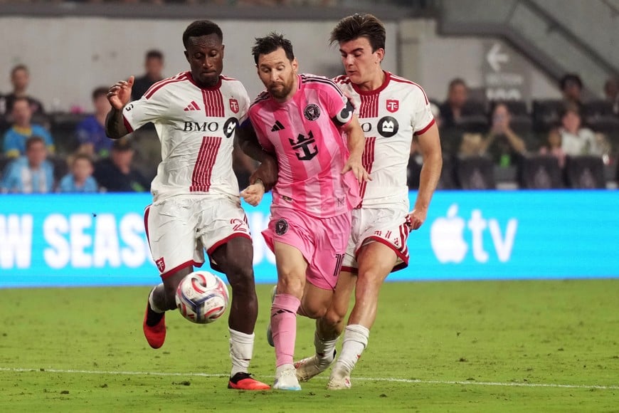 Aug 22, 2026; Miami, Florida, USA; Inter Miami forward Lionel Messi (10) is pressured by Toronto FC midfielder Alonso Coello (14) and defender Richie Laryea (22) during the second half at Miami Freedom Park. Mandatory Credit: Jim Rassol-Imagn Images