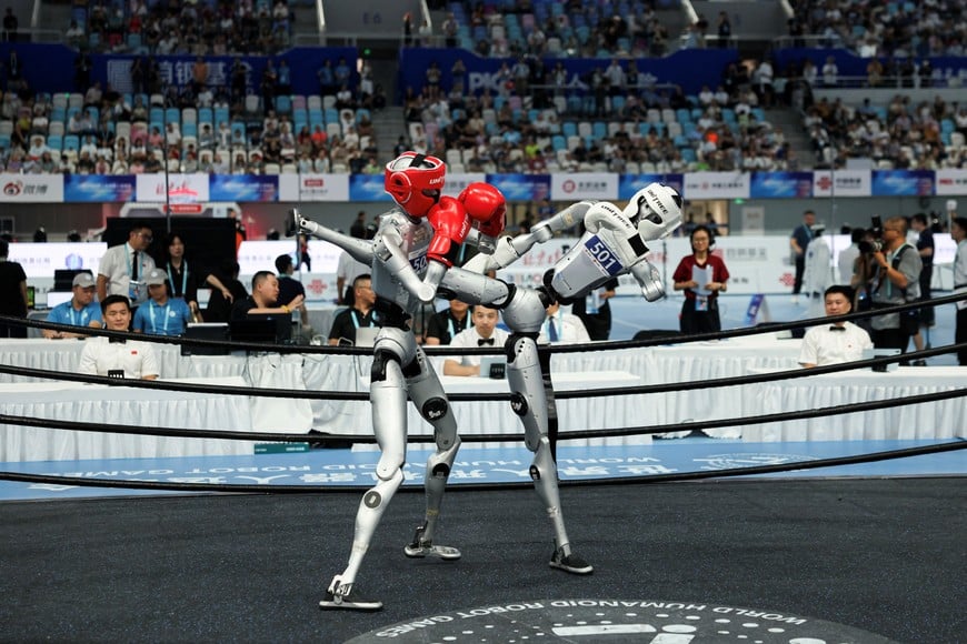 Humanoid robots by Unitree Robotics compete in the 80 kg class kickboxing quarterfinals during 2026 World Humanoid Robot Games, at the National Speed Skating Oval, in Beijing, China August 23, 2026. REUTERS/Tingshu Wang
