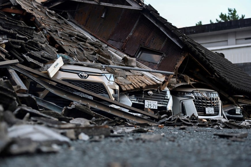 Cars sit crushed beneath debris from a collapsed building after an earthquake with a magnitude of 7.1 struck Japan's southern Kumamoto prefecture, in Yatsushiro City, Japan, July 29, 2026. REUTERS/Issei Kato TPX IMAGES OF THE DAY
