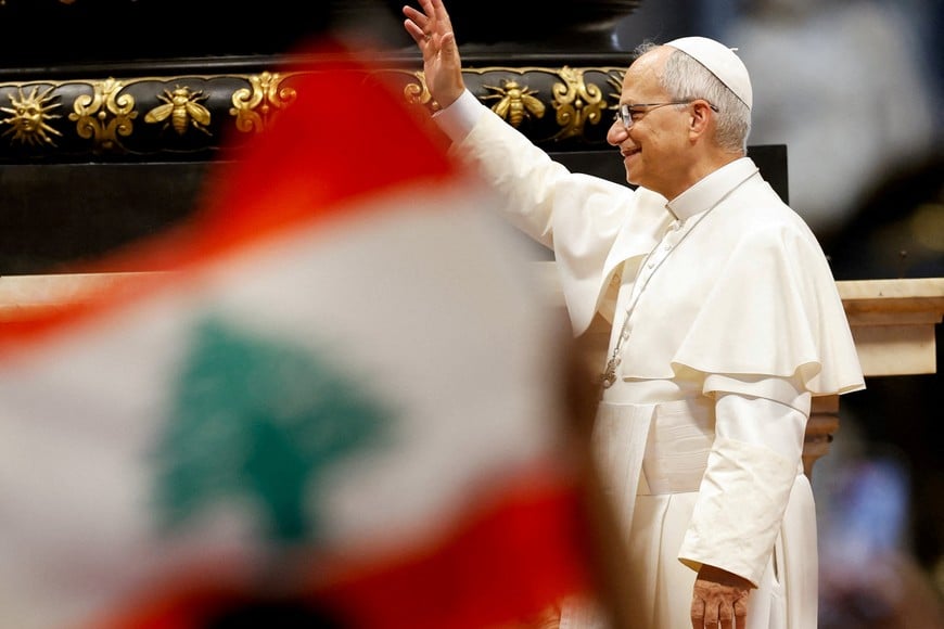 Pope Leo arrives for the weekly general audience in St. Peter's Basilica, as a person waves a Lebanese flag, at the Vatican, August 19, 2026. REUTERS/Remo Casilli     TPX IMAGES OF THE DAY