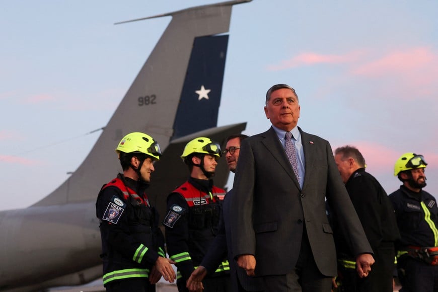 Chilean Interior Minister Claudio Alvarado walks after greeting members of Chilean fire department's Urban Search and Rescue (USAR) as they prepare to depart for Venezuela, after Chilean authorities activated a humanitarian aid response protocol following devastating earthquakes there, in Santiago, Chile, June 25, 2026. REUTERS/Pablo Sanhueza
