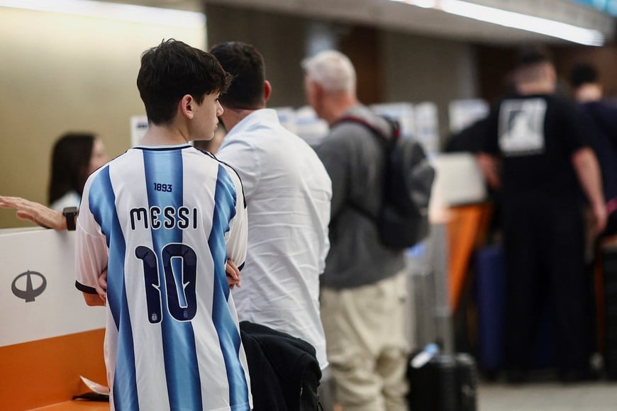 A fan wearing a Lionel Messi jersey checks in as Argentina fans scramble to board the last flights to New York to watch the World Cup final against Spain on Sunday at Ezeiza International Airport in Buenos Aires Province, Argentina, July 17, 2026. REUTERS/Tomas Cuesta