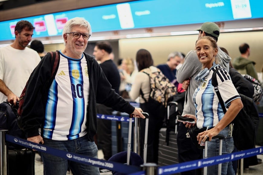 Felipe and Julieta Del Piano line up to check in as Argentina fans scramble to board the last flights to New York to watch the World Cup final against Spain on Sunday, at Ezeiza International Airport, Buenos Aires Province, Argentina, July 17, 2026. REUTERS/Tomas Cuesta