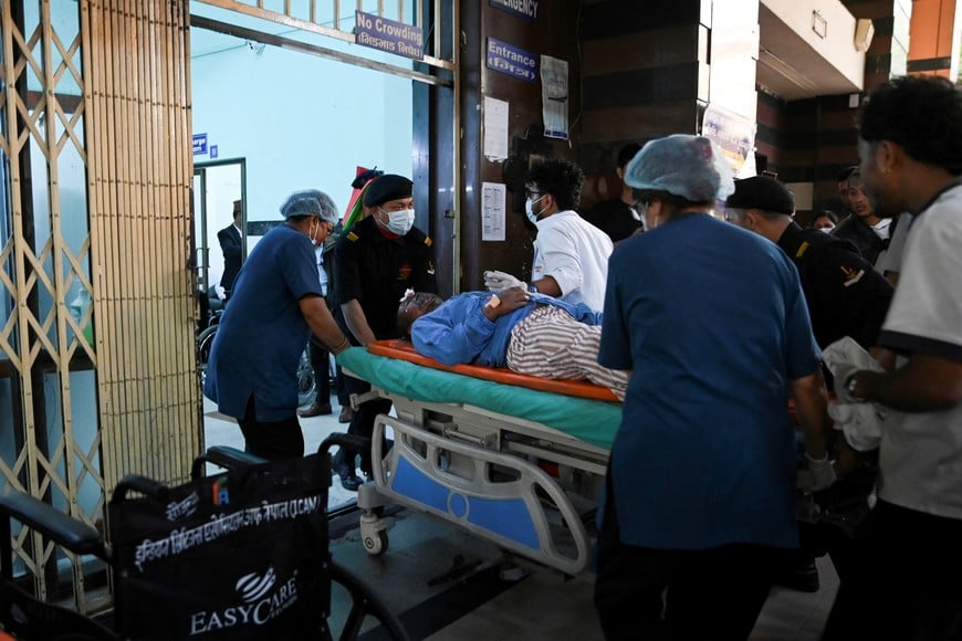 Nandu Ghale Gharti, 46, is rushed to the trauma centre of Bir Hospital after being injured in a flash flood, in Kathmandu, Nepal, August 26, 2026. REUTERS/Monika Malla