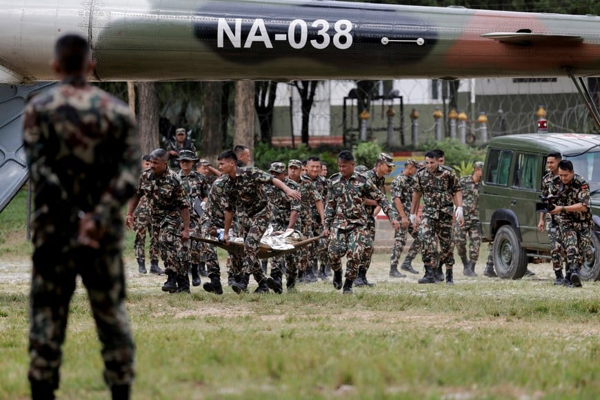 Members of the Nepali Army carry a survivor who is being airlifted following a flash flood at Trishuli in Nuwakot district, Nepal, August 26, 2026. REUTERS/Navesh Chitrakar