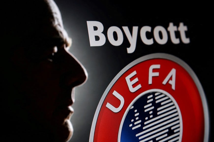 A silhouette depicting FIFA President Gianni Infantino is seen next to a UEFA logo and text reading "Boycott" in this illustration taken July 30, 2026. REUTERS/Dado Ruvic/Illustration