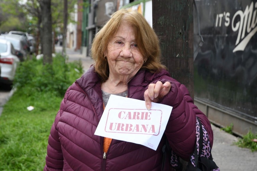 Una vecina mostrando uno de los folletos que se entregaron. Foto: Manuel Fabatía